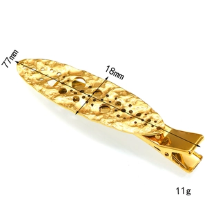 Close-up of golden metal hair clip with hammer texture and hollow design measuring 77mm