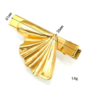 Detail view of gold floral hairpin showing dimensions 61mm by 36mm and 14g weight