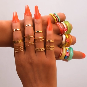 Detail of colorful resin and gold alloy rings set in bohemian and Y2K styles