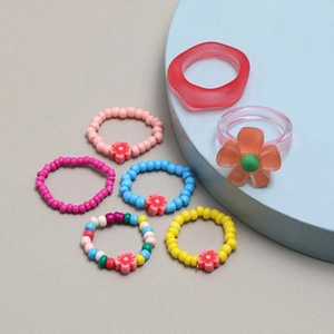 Handmade woven colorful beaded flower ring set featuring resin and acrylic charms