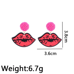 Exaggerated red lip resin earrings with magenta beaded balls and pop art aesthetic