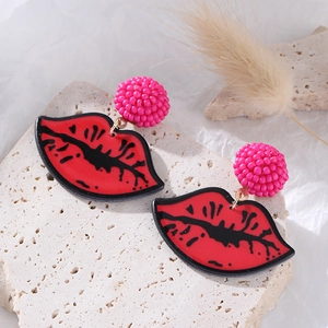 Chic red lip drop earrings with pink beaded spheres on a textured white stone base