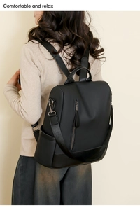 Detail of a soft black PU leather backpack showing fine texture and metal zipper