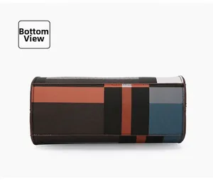 Detail view of the multi-color plaid tote bag bottom with durable brown piping