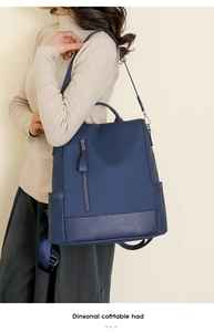 Side view of navy blue PU leather backpack showing large capacity and adjustable straps