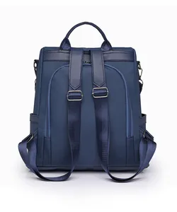 Detail view of the navy blue backpack back featuring anti-theft zipper and padded straps