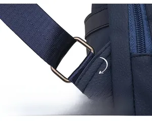 Detail of square metal ring and reinforced stitching on dark blue PU leather backpack