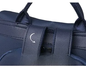 Detail of reinforced stitching and durable synthetic leather handle on the navy blue backpack