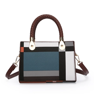 Chic geometric color-block handbag with woven handles and adjustable shoulder strap
