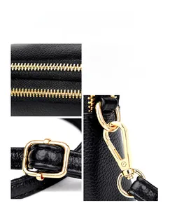 Detail of premium golden metal zipper and swivel hooks on black litchi leather bag