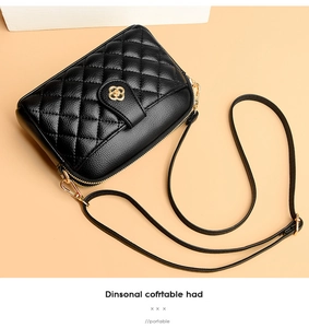 Detailed view of black quilted leather bag with elegant golden floral metal clasp
