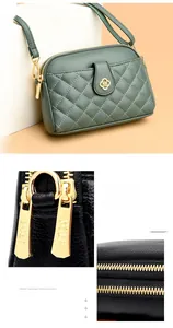 Detail of textured cowhide leather with quilted stitching and gold zipper hardware