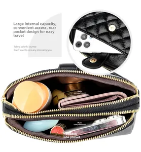 Detailed interior of black quilted crossbody bag showing three compartments and gold hardware