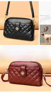 Detailed view of quilted faux leather shoulder bags in black and wine red colors