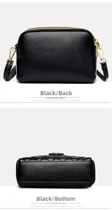 Detail view of black pebble leather crossbody bag showing base stitching and golden hardware