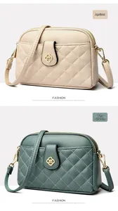Detail view of apricot and tea green quilted crossbody bags with floral metal buckles