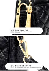 Close-up of golden zipper puller and metal hook on a black quilted leather bag