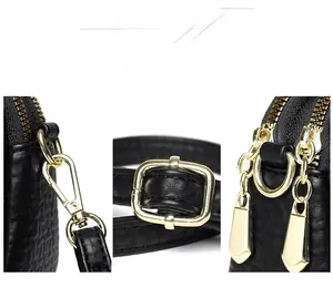 Detailed view of golden hardware accents on a black lychee texture crossbody handbag