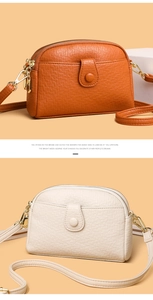 Detail of cross-body bags in orange and cream with lychee texture and dual zippers