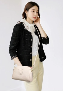 Chic beige pebbled leather crossbody bag with curved design shown on a female model