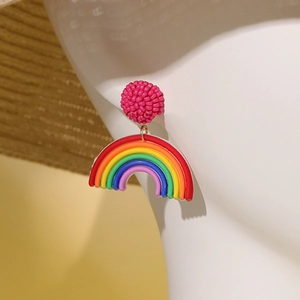 Colorful rainbow beaded pendant earrings for women on a summer vacation theme background