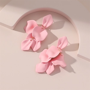 Vue détaillée de boucles d'oreilles pétales en résine rose à texture mate et anneaux