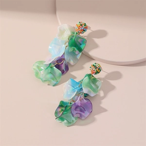 Détail de boucles d'oreilles pompons feuilles en résine avec pétales colorés dégradés