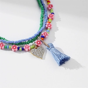 Colorful multilayer African waist beads with heart pendant, tassel, and floral accents