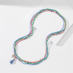 Detail of multi-layer beaded waist chain with pink flowers, blue tassel and heart charm