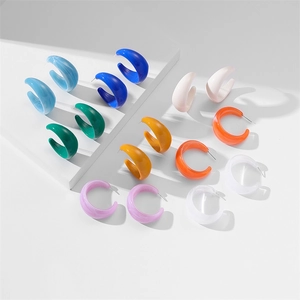 Collection of chunky C-shaped acrylic earrings in eight vibrant colors on white background