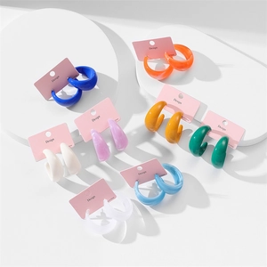 Close-up of vibrant C-shape acrylic hoop earrings in eight colors on display cards