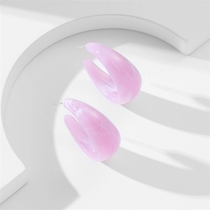 Detailed macro view of pastel purple acrylic C-shaped earrings with marble texture