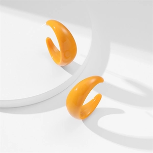 Fashionable bright orange C-shaped acrylic hoop earrings for women on minimalist stand