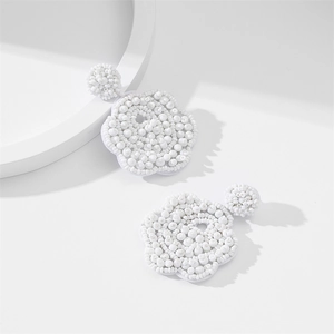 Handmade white beaded plum blossom earrings with intricate seed bead floral design