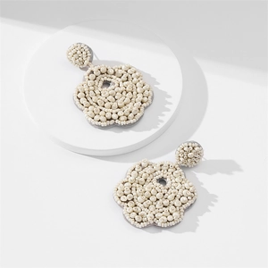 Handmade bohemian beaded plum blossom earrings in cream white with soft grey felt backing