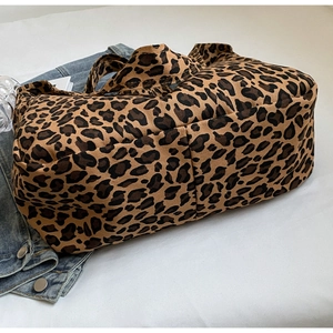Detailed close-up of large leopard print canvas tote bag with brown pattern