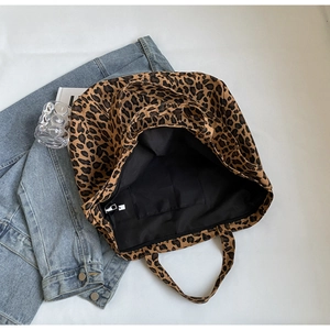 Close-up of leopard print tote bag interior featuring a secure metal zipper pocket