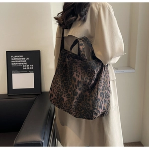 Lifestyle view of large capacity leopard print tote bag styled with casual wear