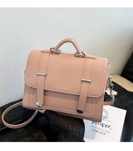 Pink lychee texture handbag featuring silver buckles and adjustable shoulder strap detail