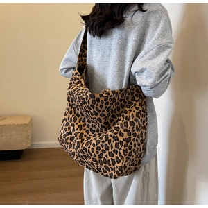 Close-up of leopard print canvas hobo bag showing large capacity and soft fabric texture