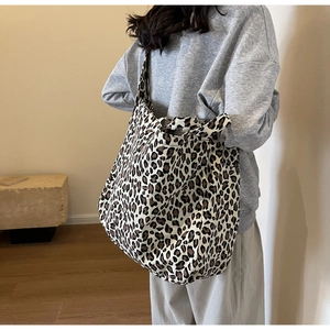 Detail of stylish large leopard print canvas tote bag with high-density fabric texture