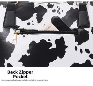Detail of the back zipper pocket on cow print tote bag with power bank inside