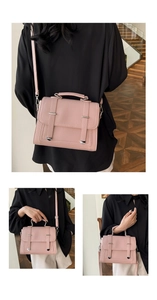 Detail view of pink lychee leather handbag with silver accents and adjustable shoulder strap