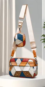 Detailed close-up of textured patchwork crossbody bag and matching round coin purse