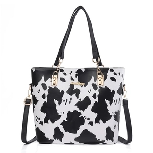 Fashionable cow print tote bag with gold hardware and adjustable strap for women