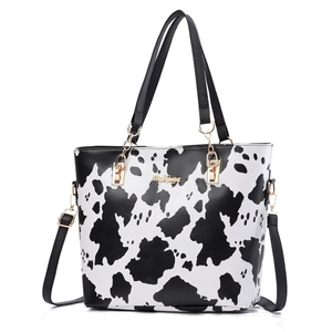 Chic cow print tote bag with gold hardware and detachable shoulder strap for daily use