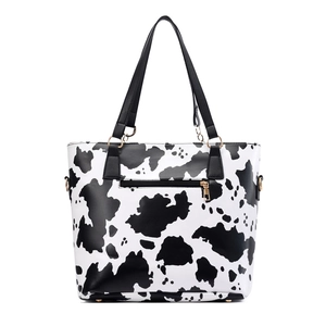 Cow print tote bag with gold hardware and front zipper pocket for daily fashion