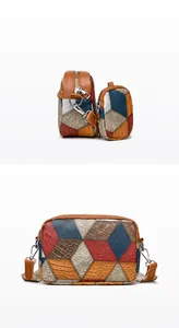 Detail of color-block shoulder bag with textured leather and adjustable fabric strap