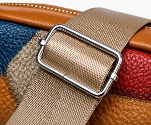 Detail of lychee pattern leather contrast stitching and silver metal strap adjuster buckle