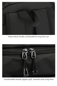 Detail of water-resistant black backpack showing woven handle and smooth dual zippers